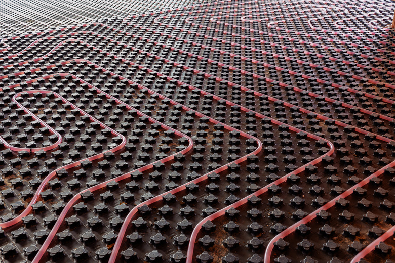 Underfloor heating system installation. Close up on water floor heating system interior of a new residential building. Pipes filled with propylene glycol. Individual Heating.