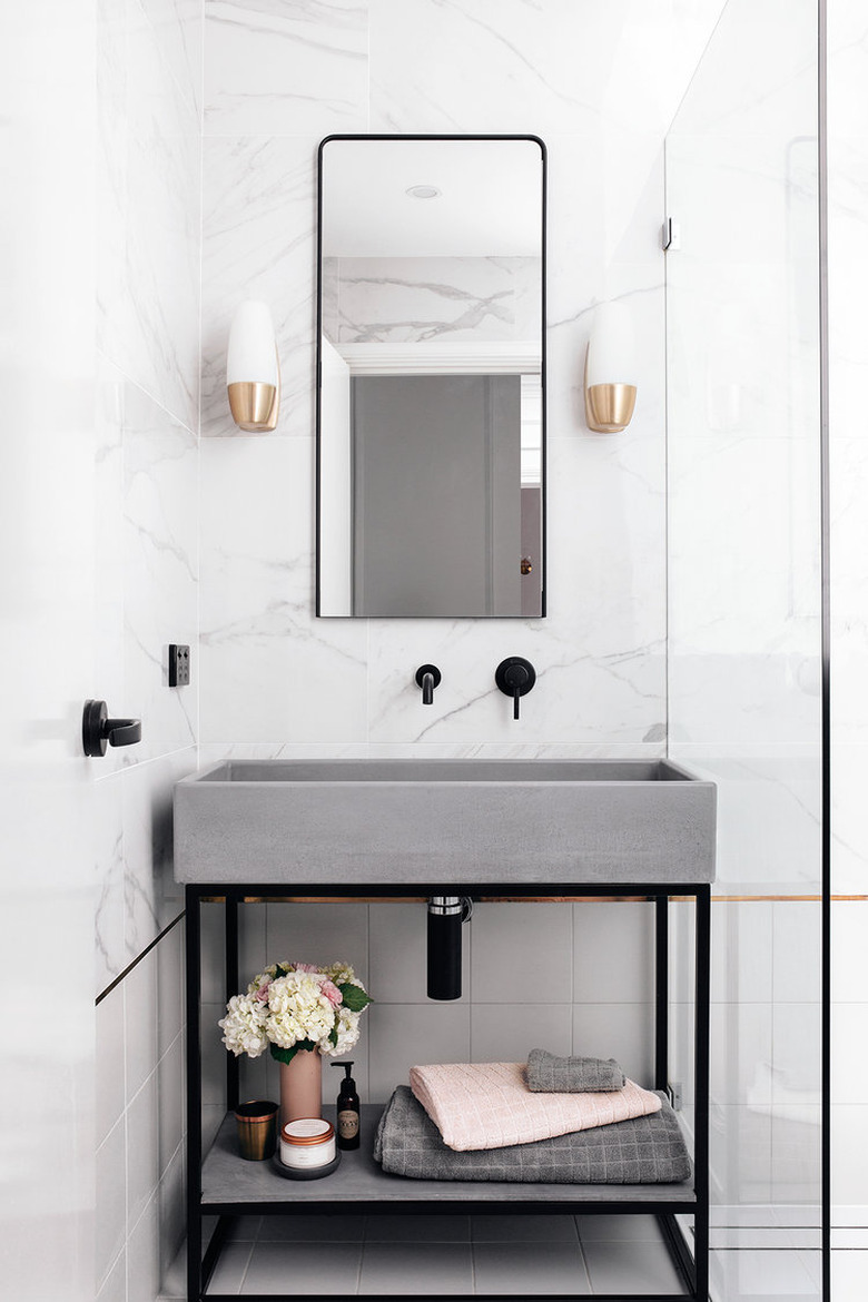 concrete sink in powder room with black fittings