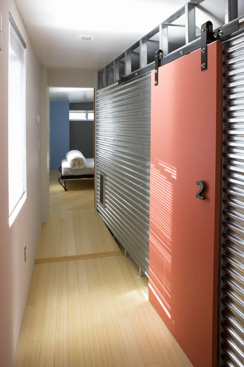 Coral Contemporary Barn Doors on galvanized steel walls.