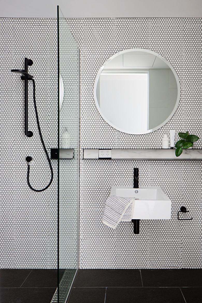 Monochrome utilitarian bathroom with beehive tiles