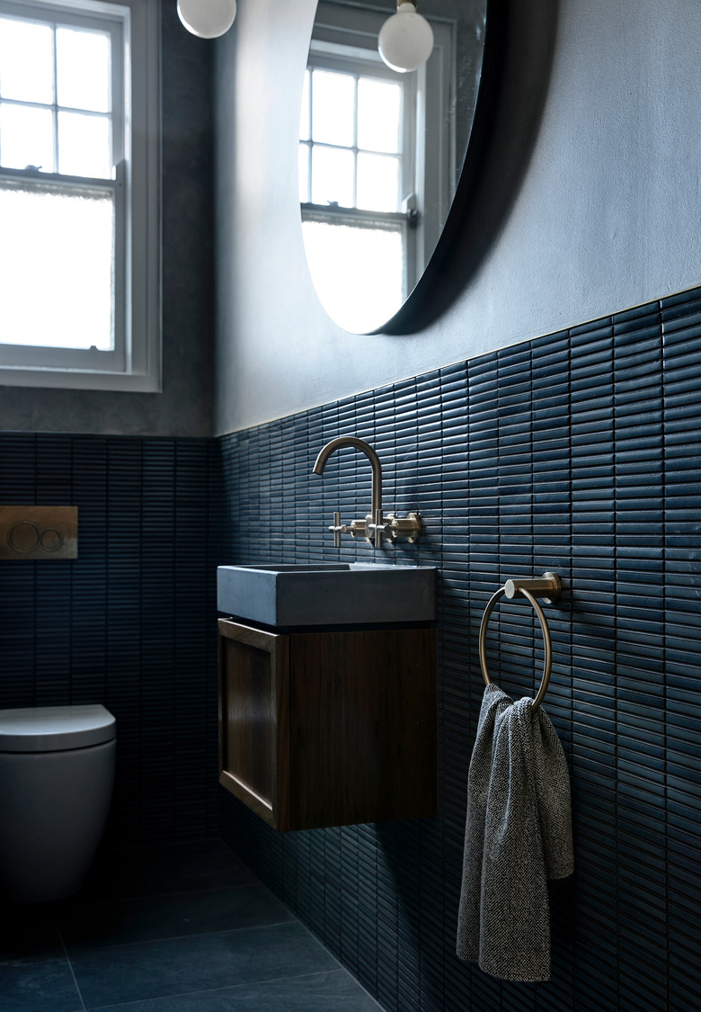 moody bathroom with gray walls and dark wall tile