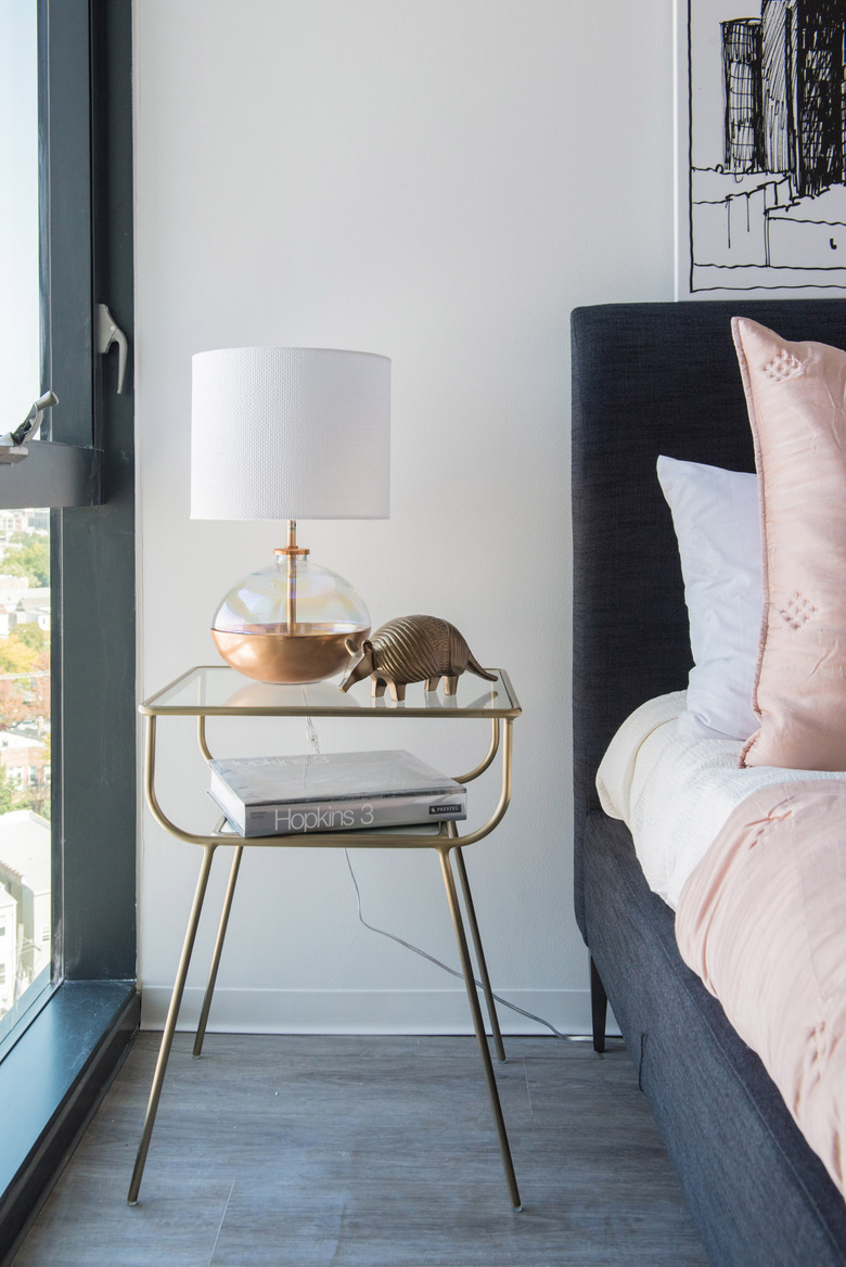 A glass and gold nightstand