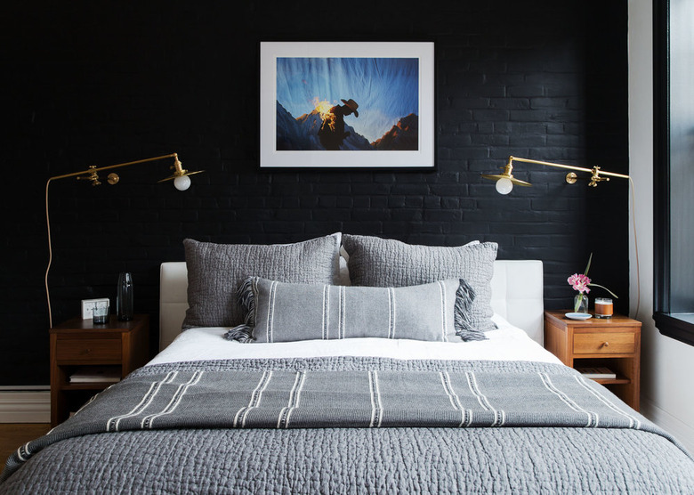 bedroom with black brick accent wall