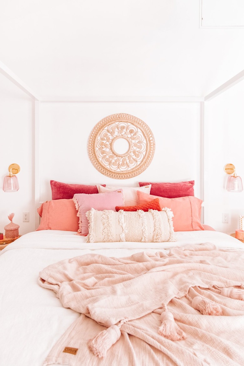 Pink glass sconces in bedroom