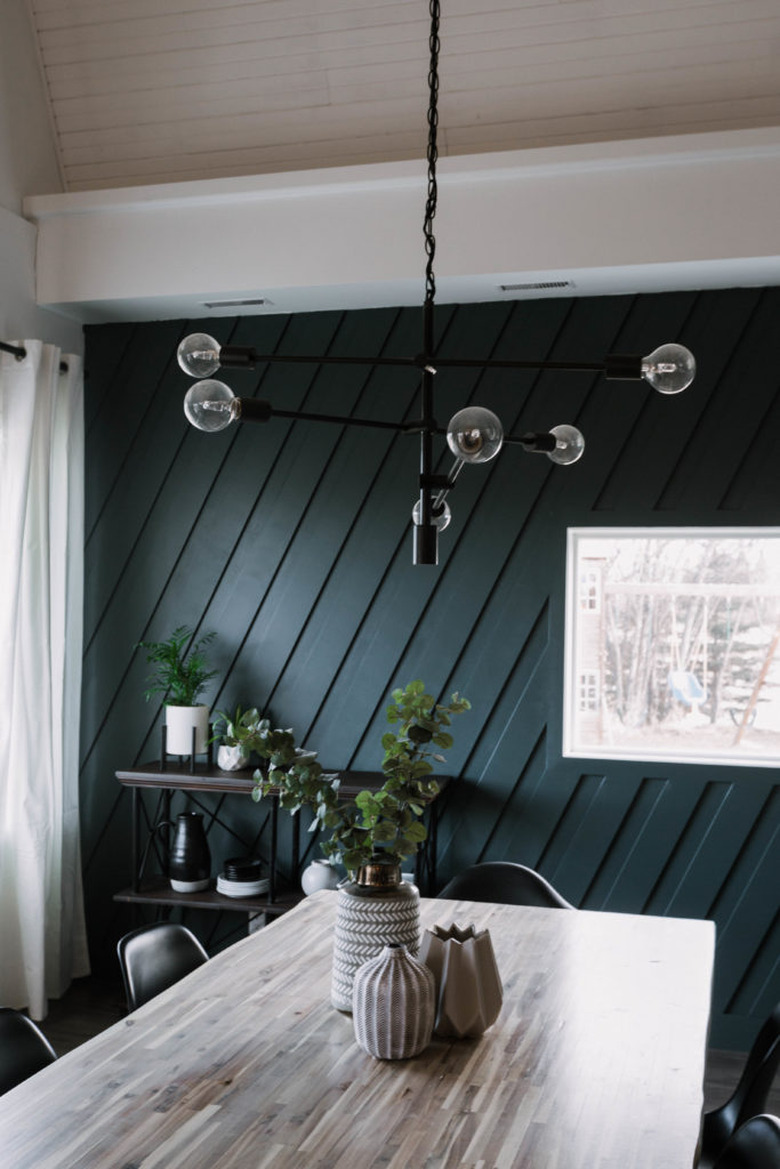 Blue and black dining room lighting idea with contemporary light fixture