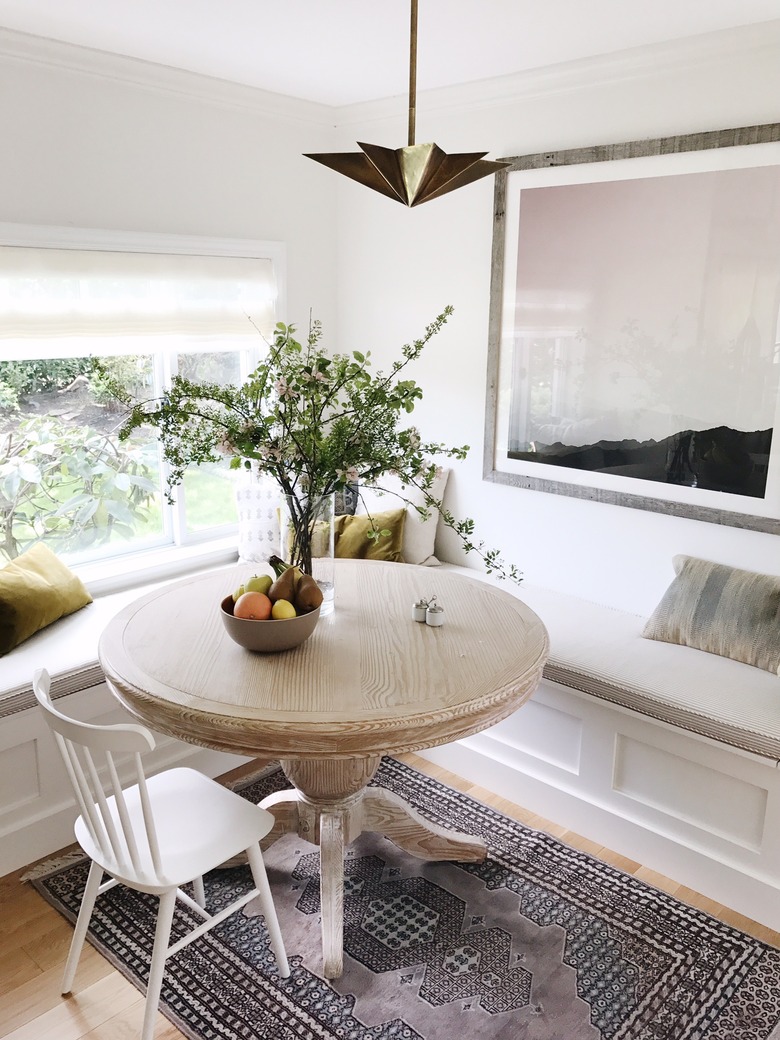 Transitional dining room lighting idea with brass contemporary light fixture