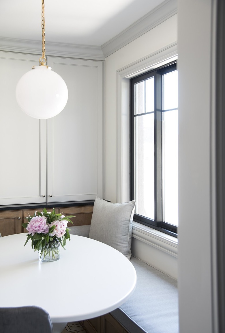 Contemporary dining room lighting idea with midcentury pendant light