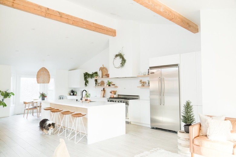 White boho kitchen with large white island and counter stools and contemporary Kitchen Island