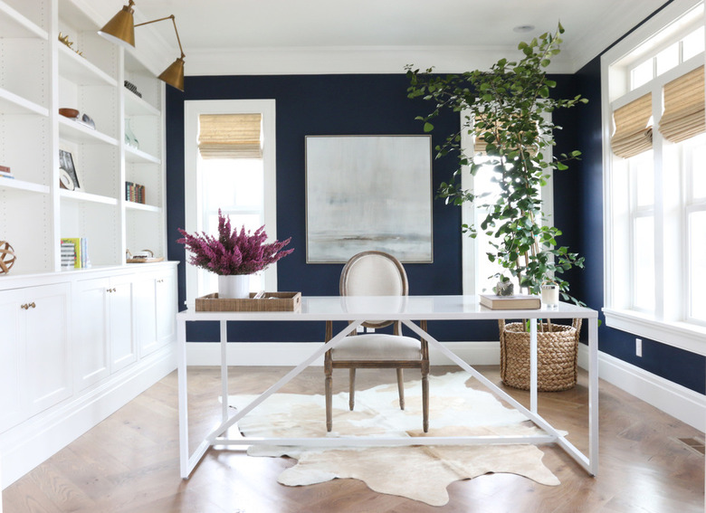 contemporary office with blue walls and open shelving