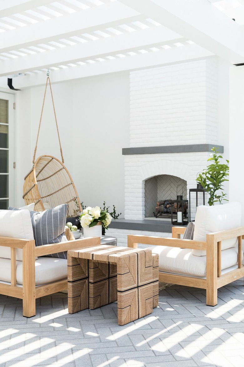 White contemporary pergola with sunlight and modern furniture