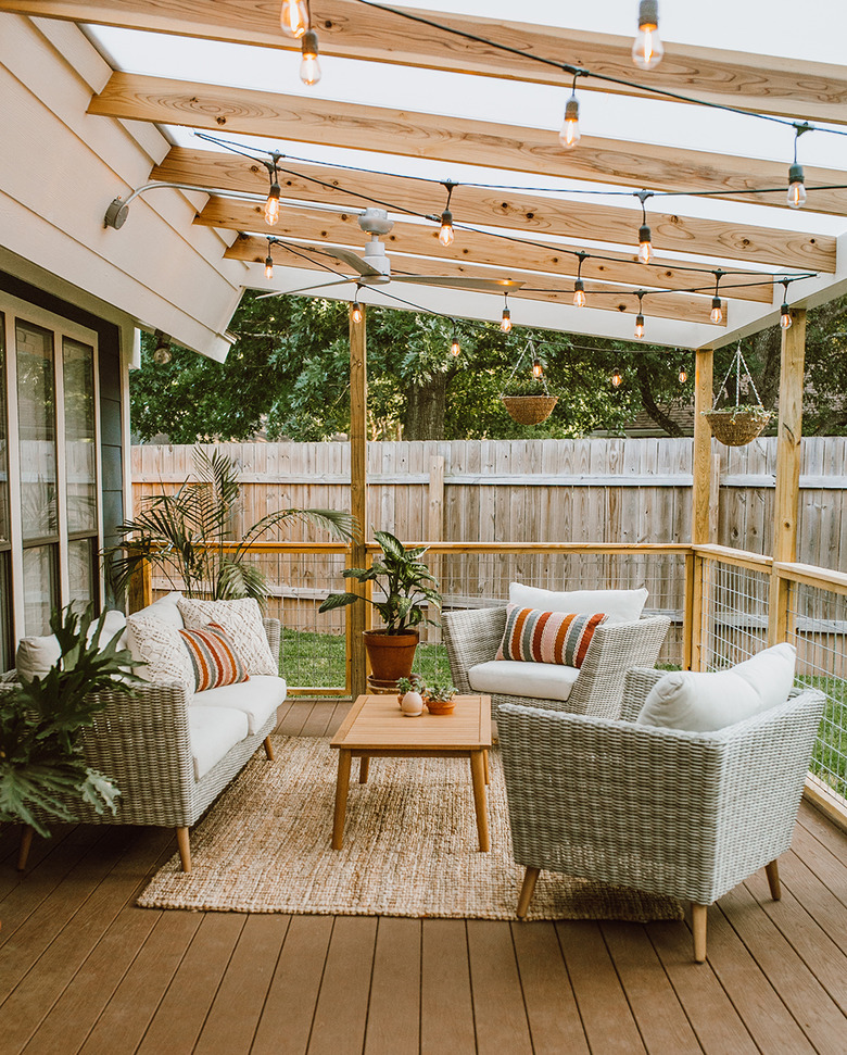 Angled wood contemporary pergola on deck with outdoor furniture