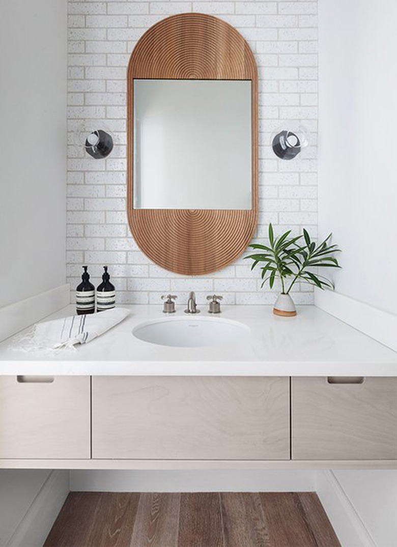 white boho space with undermount bathroom sink and floating vanity and subway tile backsplash