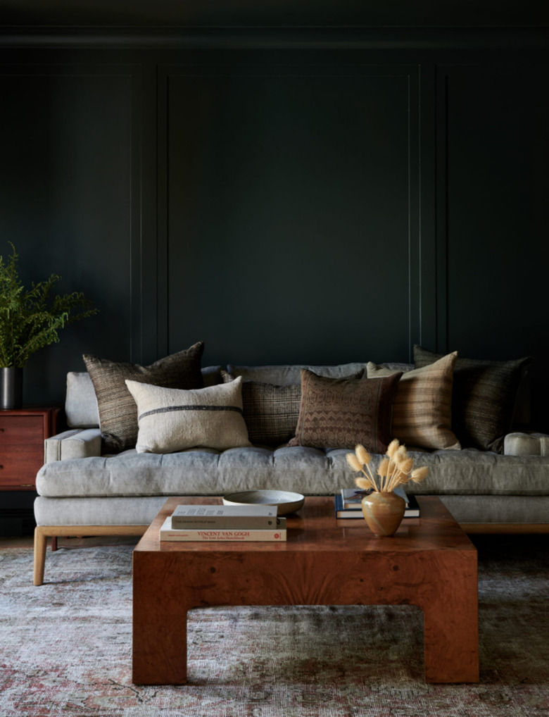 living room with gray couch and coffee table with cool colors