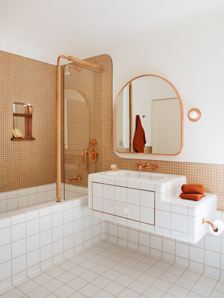 Bathroom designed by Home Studios NYC with copper bathroom faucet and shower