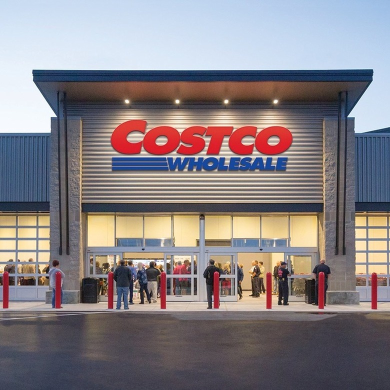 Costco storefront with logo and people in the front waiting on line.