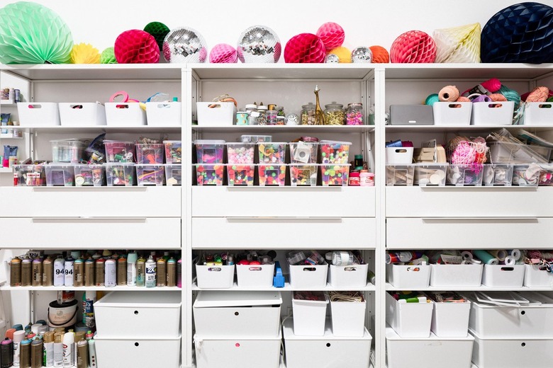 Craft Storage Shelves with craft supplies in white and clear containers.