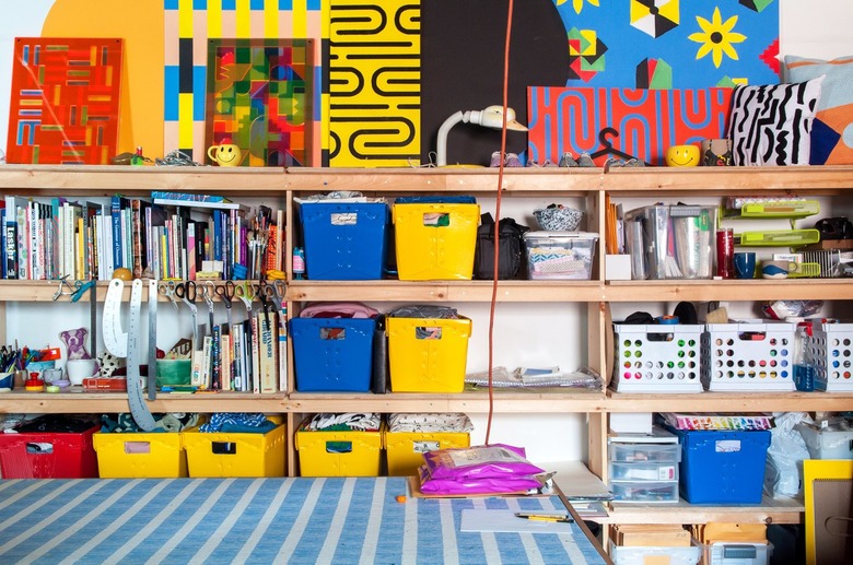 Craft Storage Shelves with colorful containers in yellow, red, blue, books, supplies.