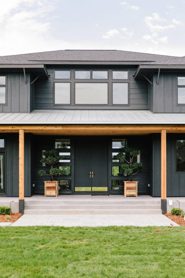 Black Craftsman home exterior with natural wood beams