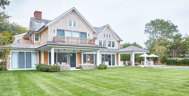 craftsman and modern style house on green lawn