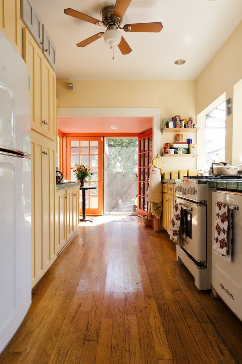 Yellow craftsman kitchen cabinets in Craftsman style kitchen with wood flooring