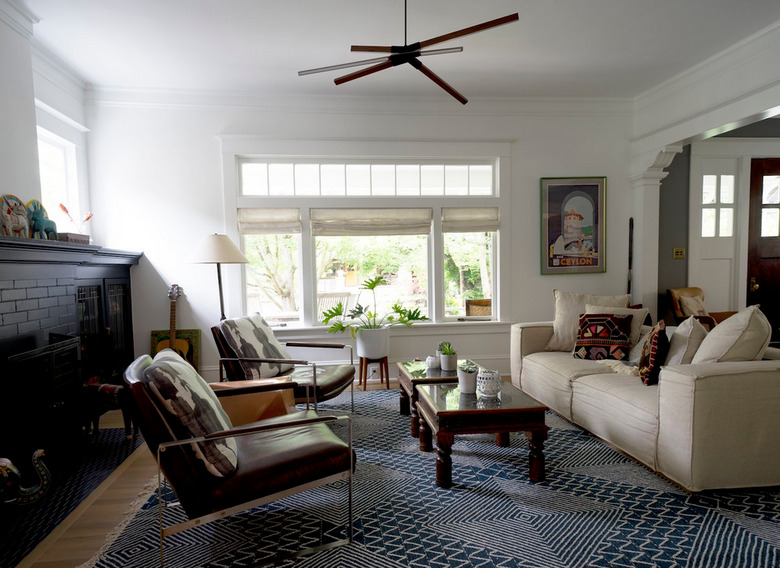 Craftsman living with black painted fireplace and modern chandelier