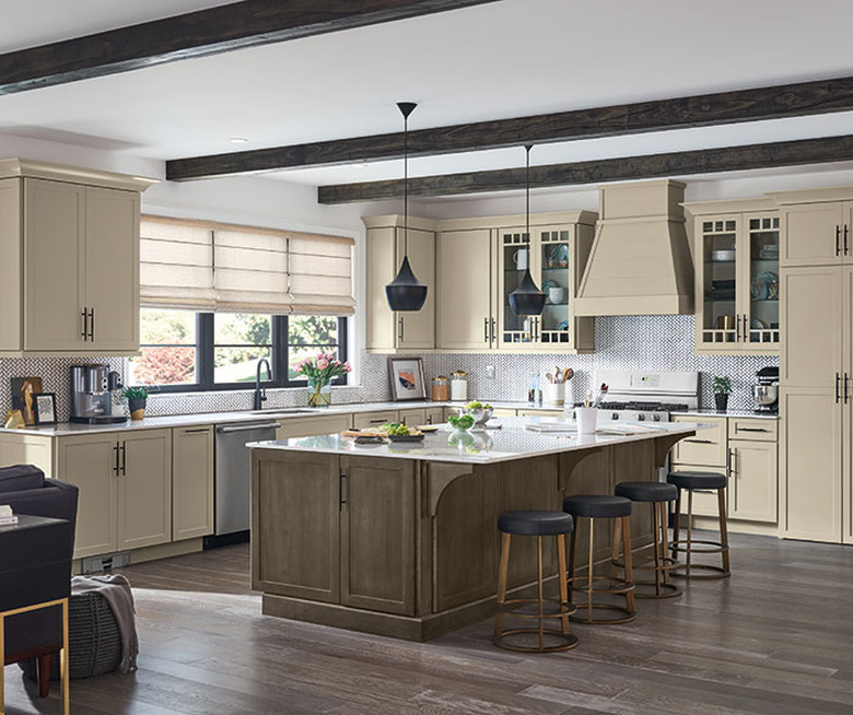 cream color cabinets in kitchen with exposed beams