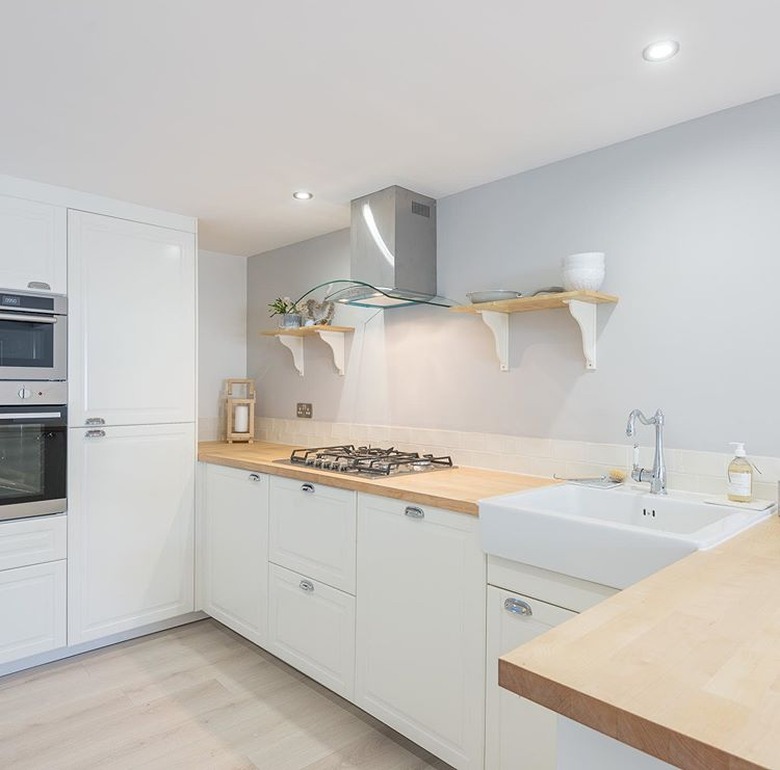 kitchen space with white cabinets and light hardwood floor