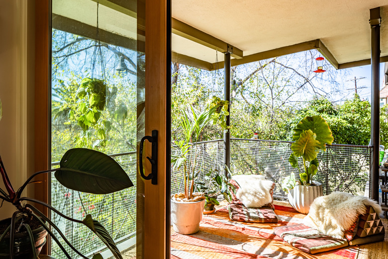 Boho chic balcony with seating area and hanging plants