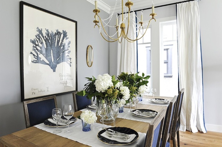 Dining room with gray walls and white curtains.