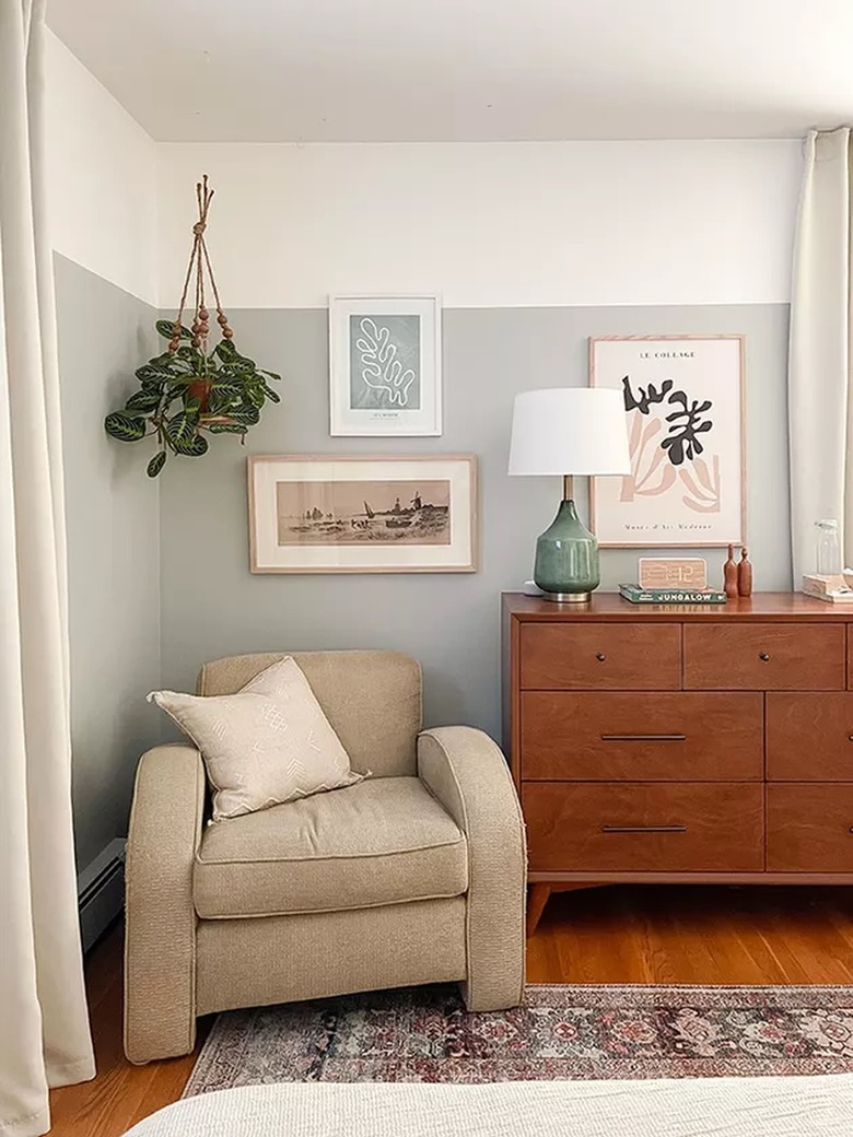 room with two-toned gray and white wall and cream curtains