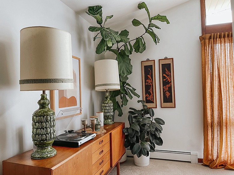 Fiddle Leaf Fig plant with a wood sideboard, with retro, green and neutral accents.