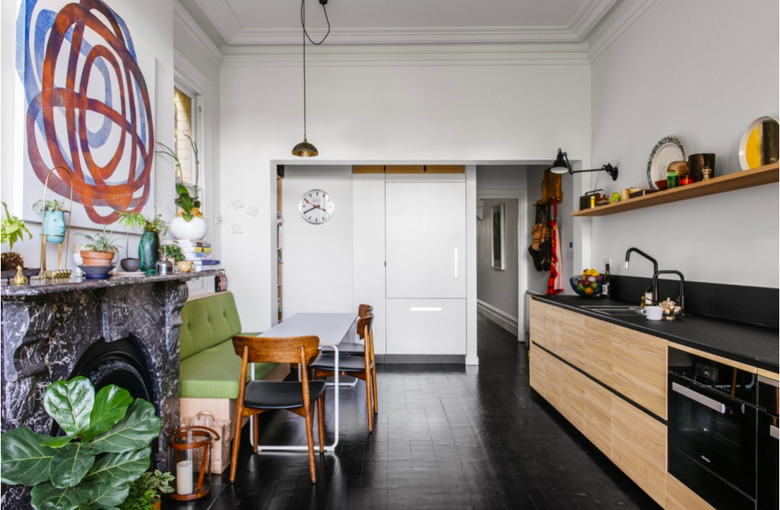 monochrome space with black wood and dark kitchen floors of laminate planks