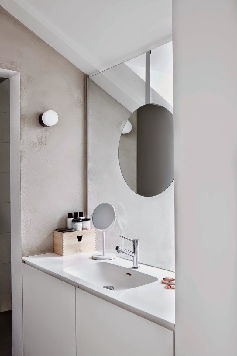 monochrome bathroom with deck-mounted facuet on white countertop