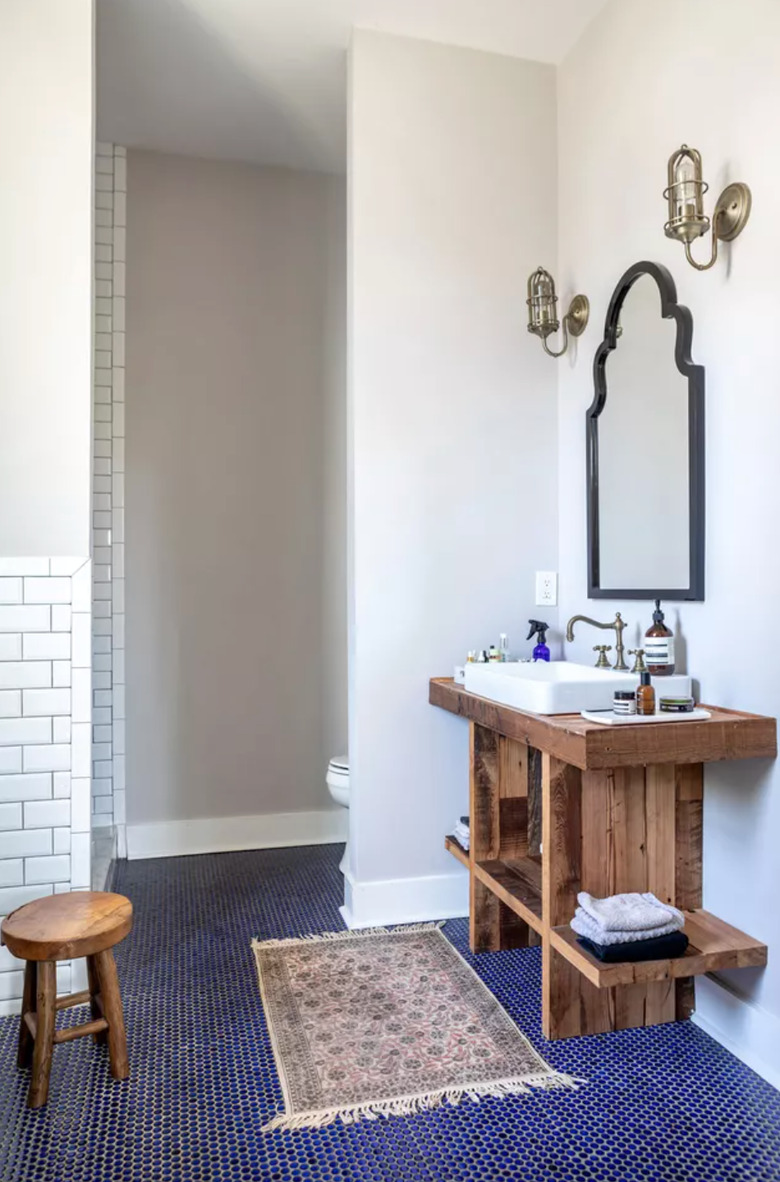 blue and white bathroom with reclaimed wood vanity and deck-mounted faucet