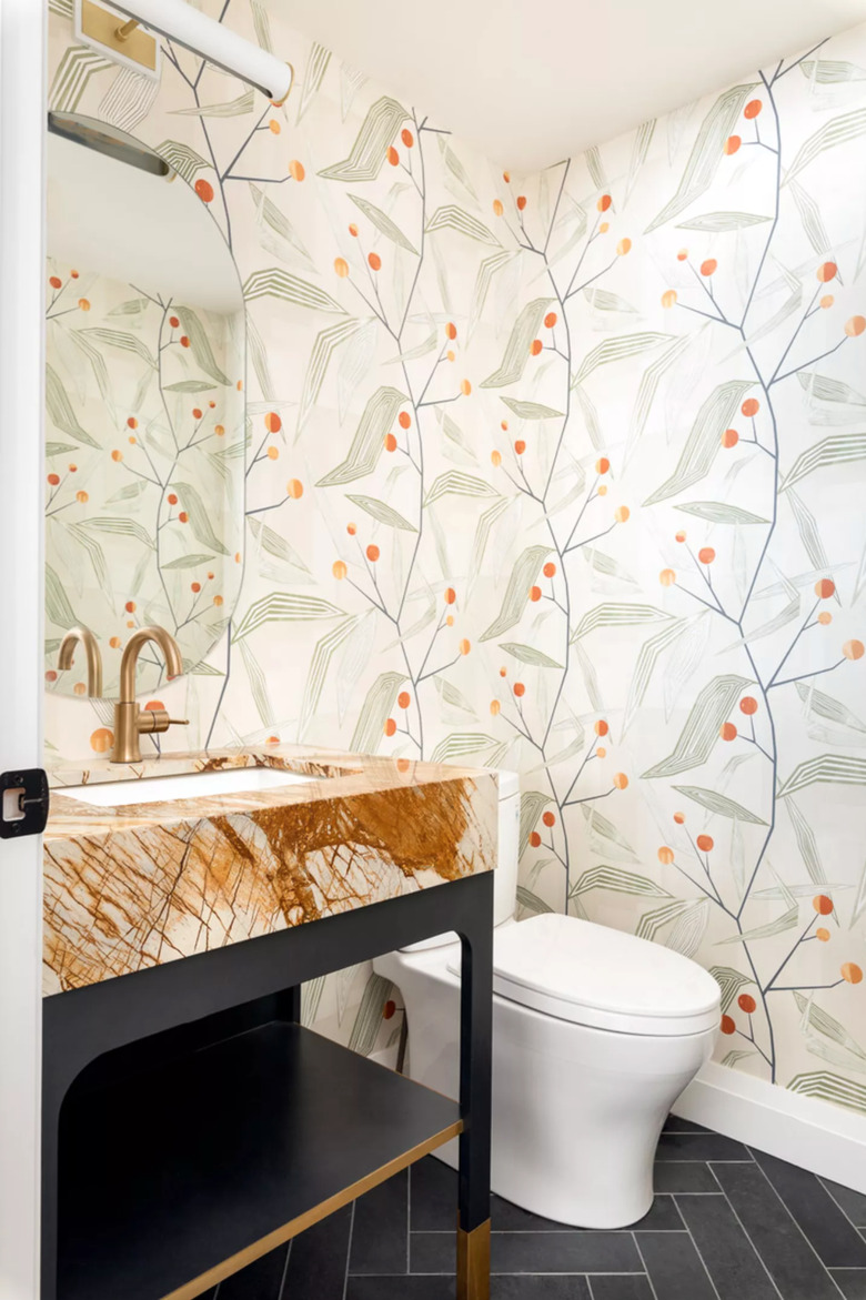 powder room with botanical wallpaper and marble sink with deck-mounted faucet