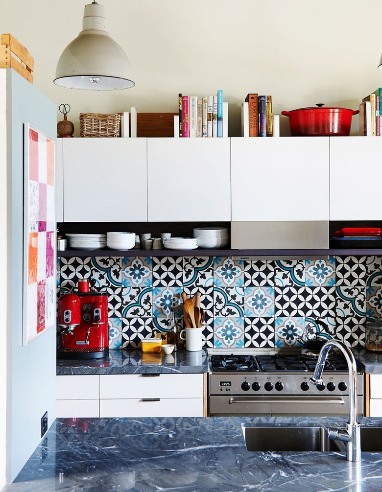 books stored above white kitchen cabinets