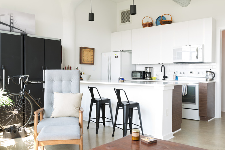 kitchen with white cabinets with baskets atop them