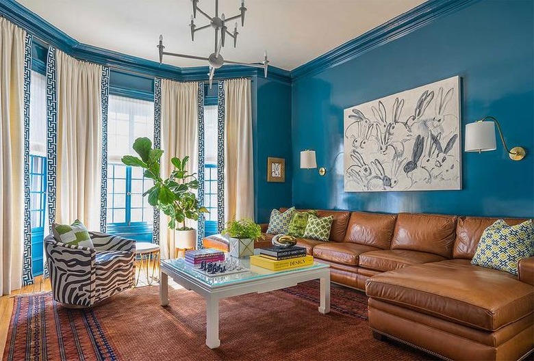 brown leather sofa in room with blue walls