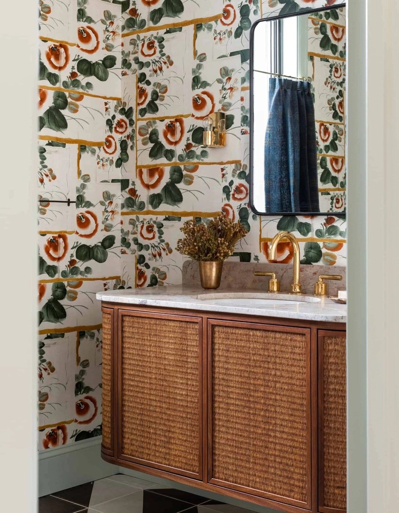 A bathroom with blue, red, and green wallpaper.