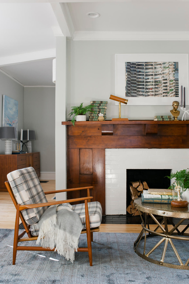 cozy living room with plaid accent chair in front of a fireplace