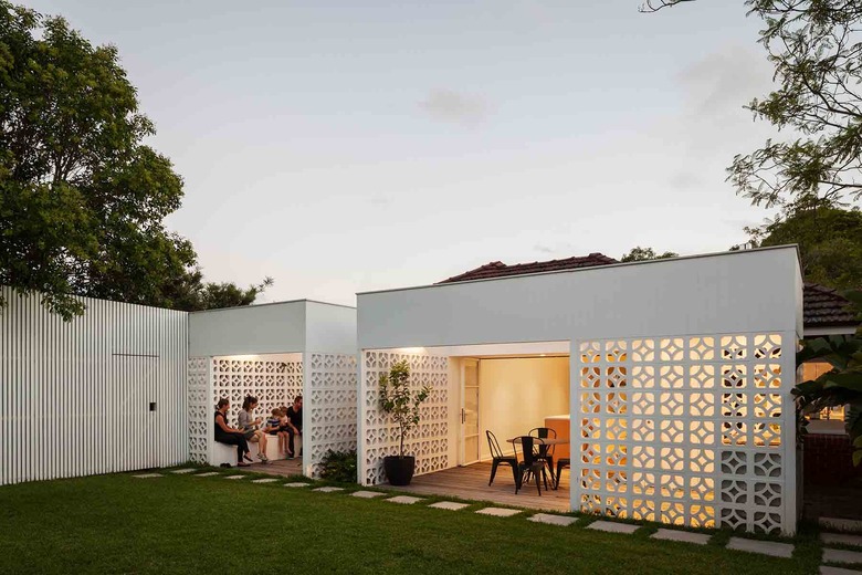 Desert style home with white breeze blocks and backyard