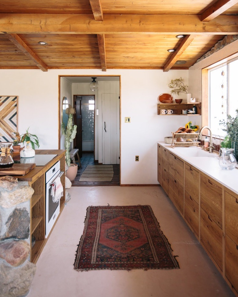 Desert-Themed Kitchen with wood cabinets and ceiling by Joshua Tree House