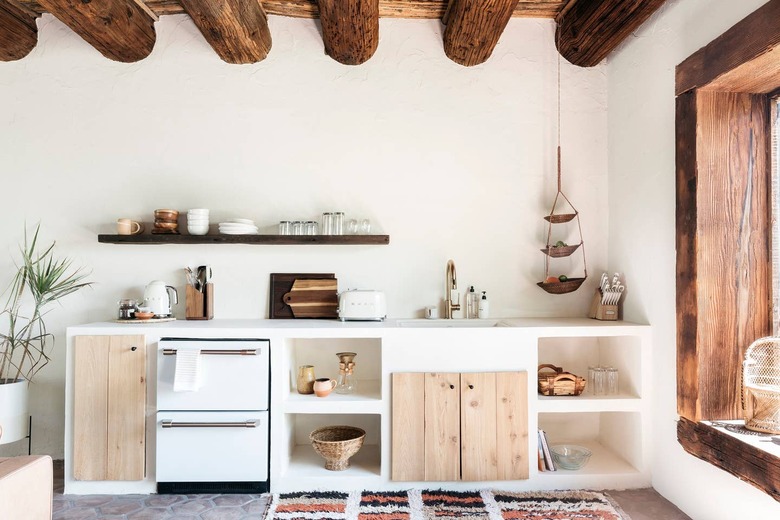 desert themed kitchen with with exposed ceiling beams and rustic wood accents by Joshua Tree House