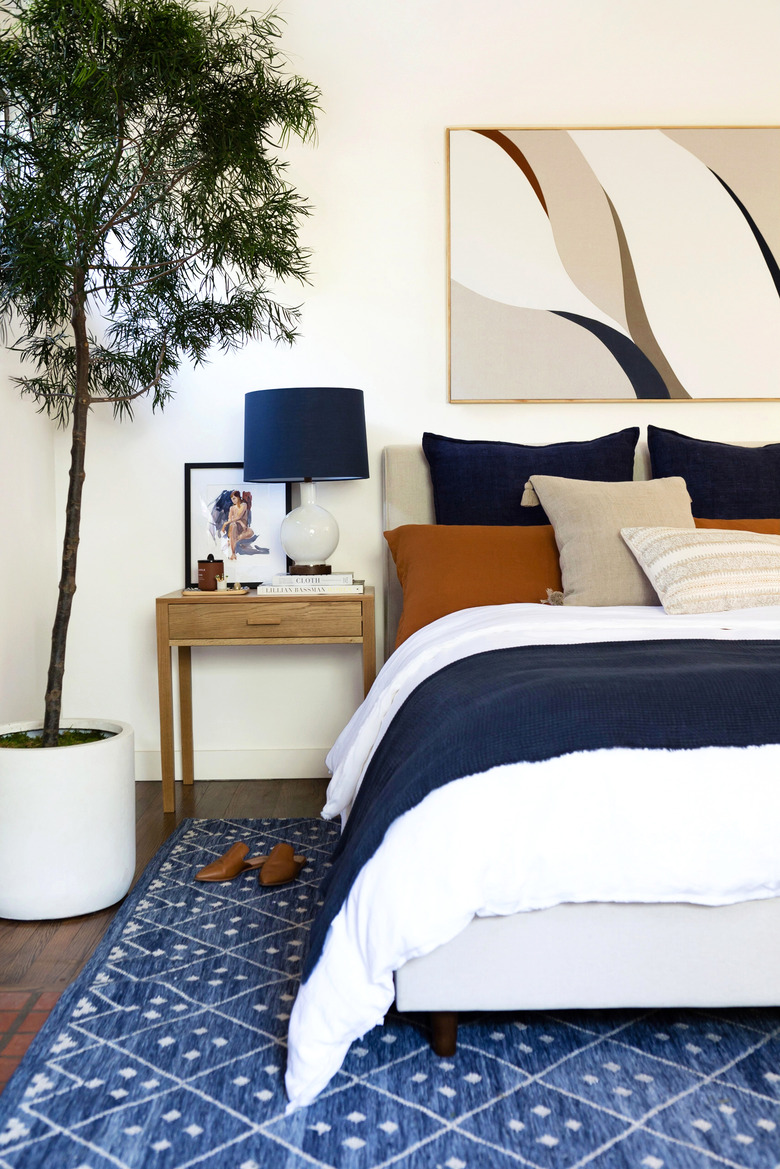 bedroom with navy, white, and rust color palette