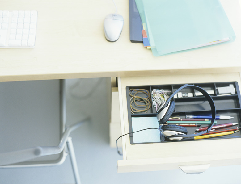 Headset in open desk drawer,high angle view