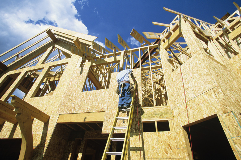 Man working at new home construction, low angle view