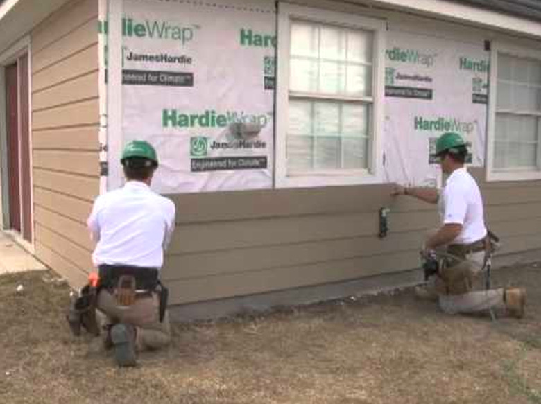 Installing siding planks.