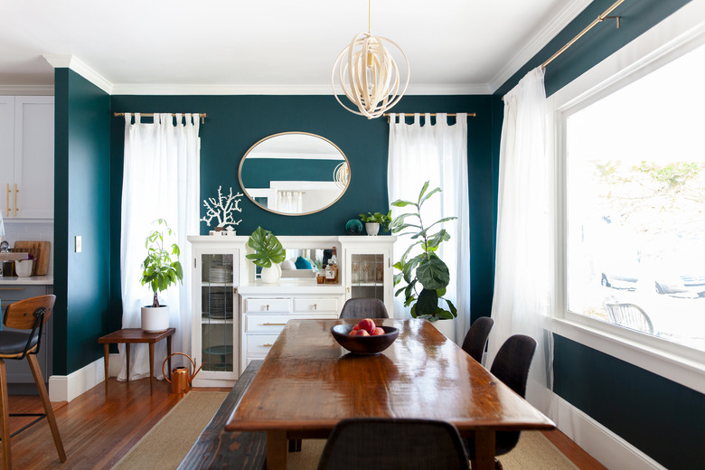 bright green dining room color idea with wood flooring and dining table