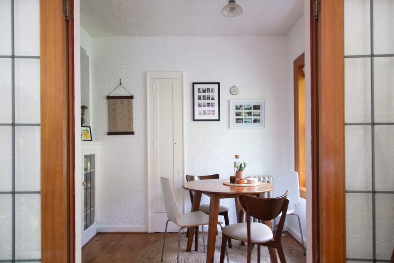 Minimalist dining room with modern table and chairs and wall art