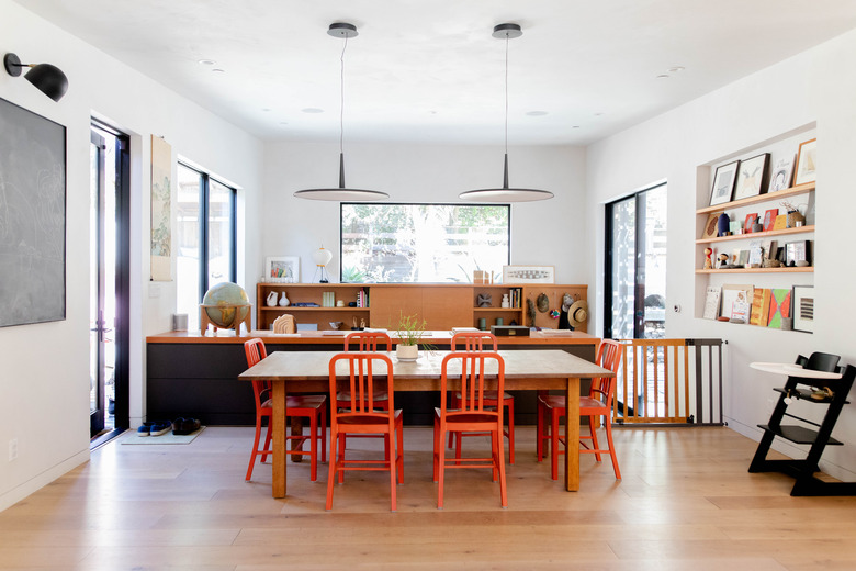 dining room idea with colorful chairs and open shelving on wall